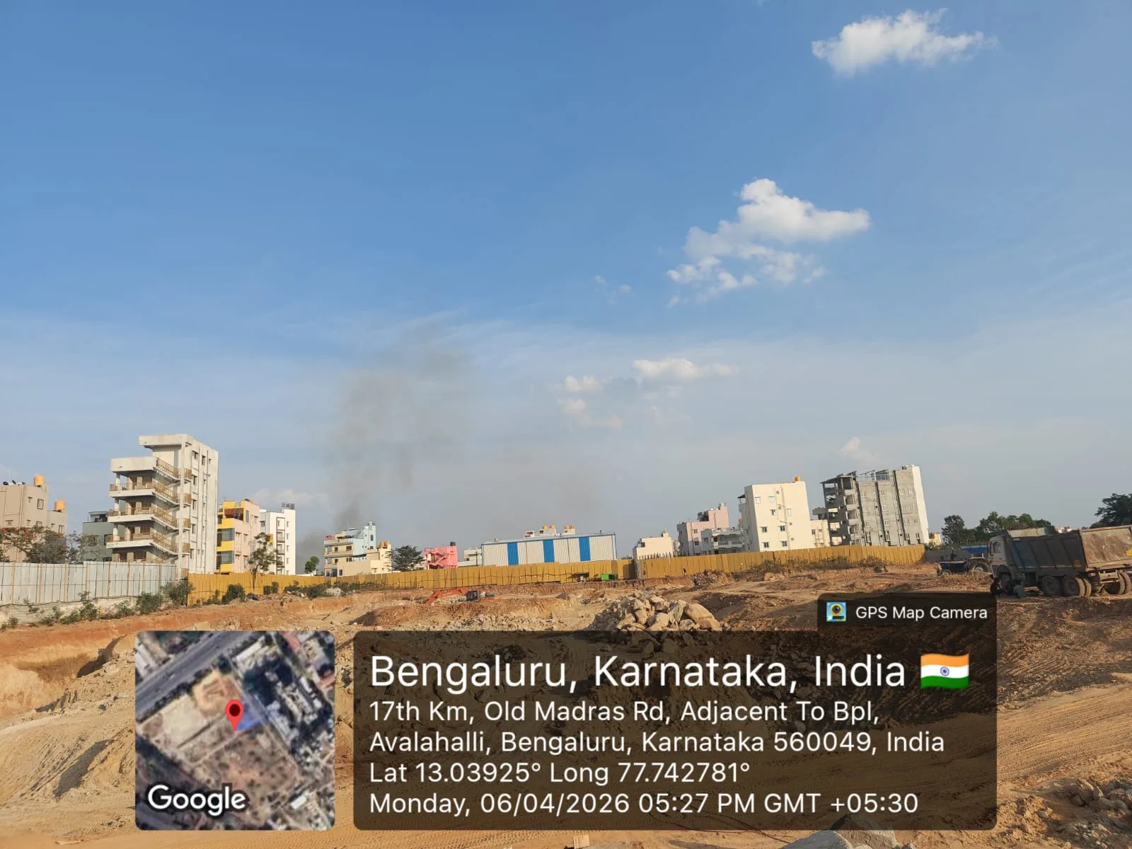 Sattva Aangane site earthwork on 6 April 2026 viewed across the Old Madras Road frontage, Avalahalli, Bengaluru